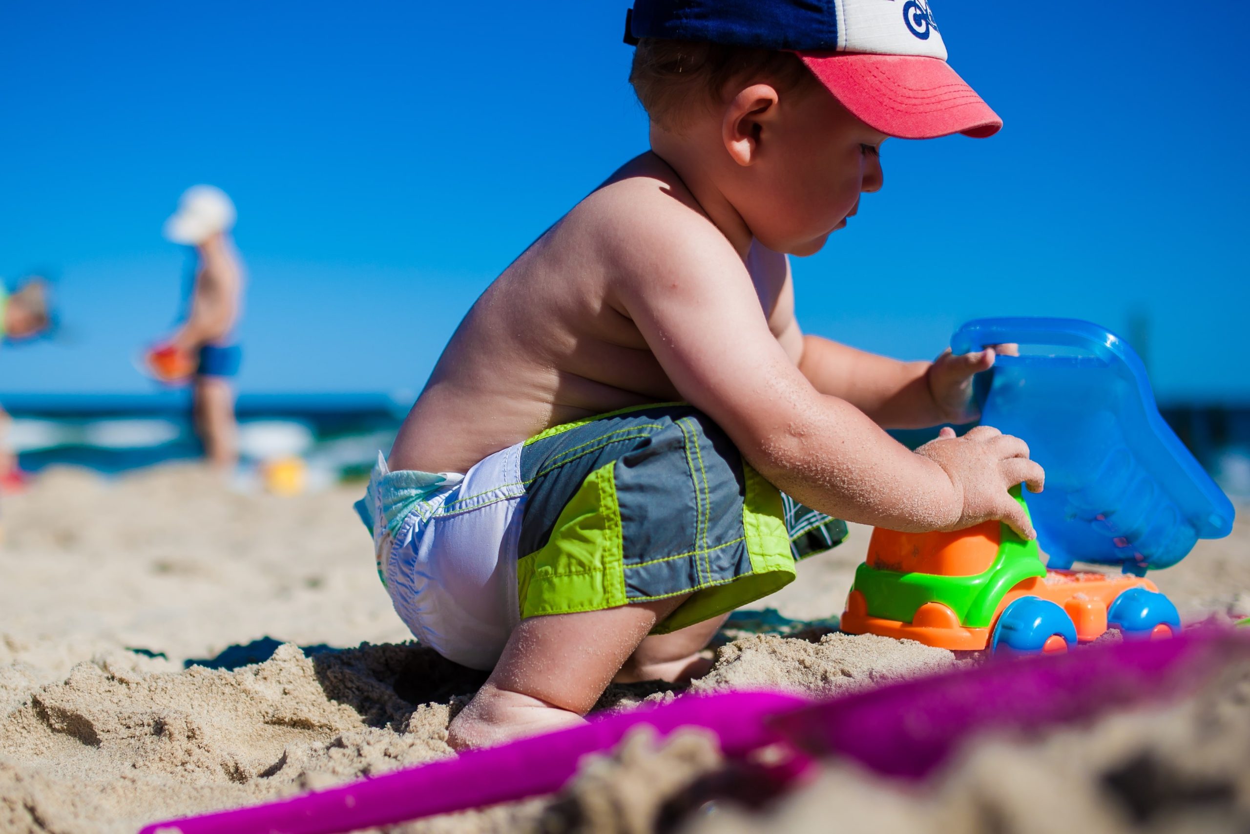 Boy playing with sand at Beach.